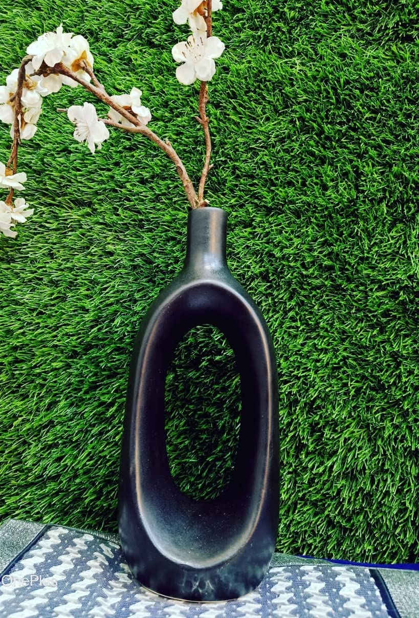 Premium handmade ceramic black hollow-shaped vase by Caffeine, decorative home accessory for living room, bedroom, office, and tabletops.