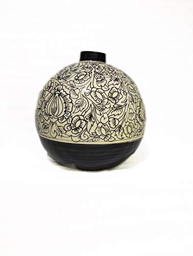 A handmade black ceramic vase with a floral Matki design.