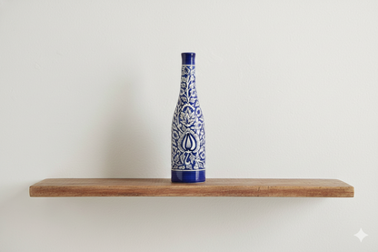 Blue and white ceramic bottle on a wooden shelf against a white background