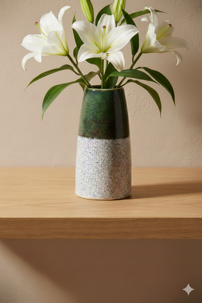 White flowers in a ceramic vase on a wooden shelf with a beige wall background