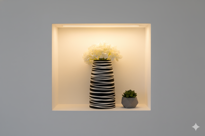 Decorative vase with striped pattern and white flowers on a gray background