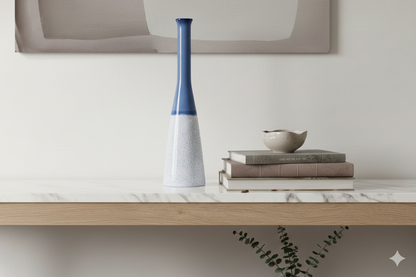 Decorative vase and books on a marble surface with a neutral background