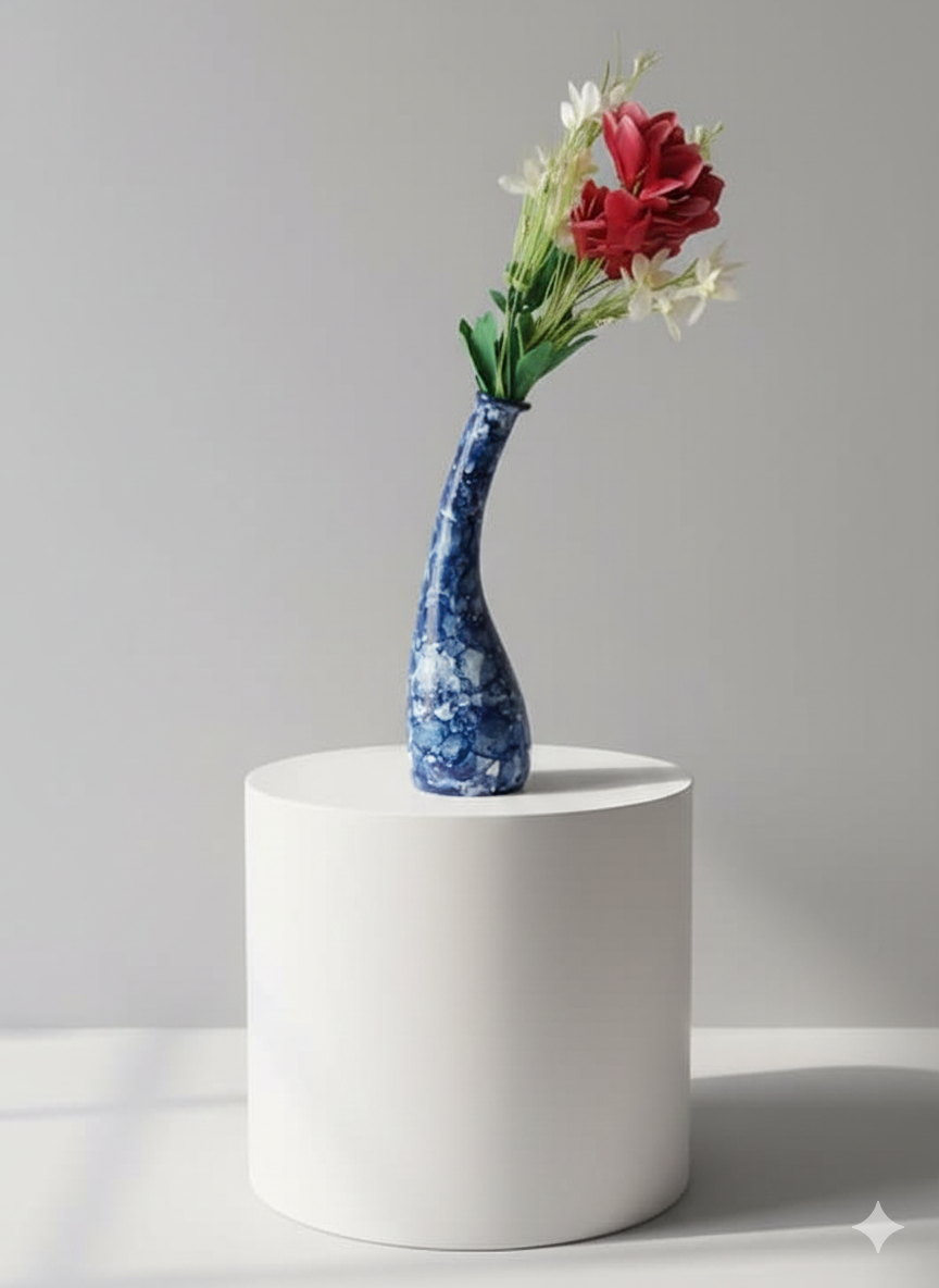 Blue and white patterned vase with red flowers on a gray background