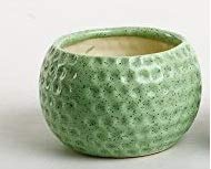 A handmade green ceramic vase with a textured surface and rounded edges.