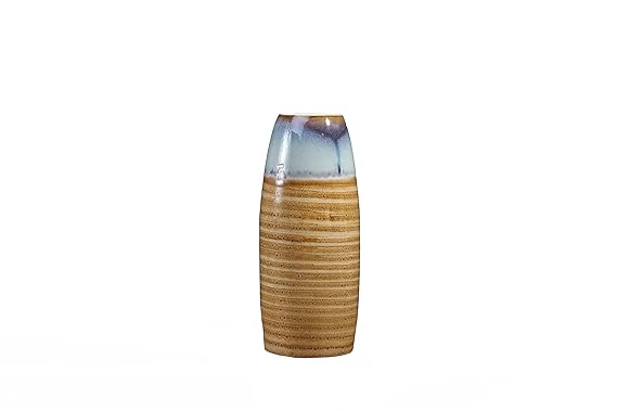 A ceramic vase with a glossy finish, featuring white and mustard colors, with a rounded shape on a white background.