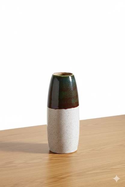 Two-toned ceramic vase on a wooden surface with a white background