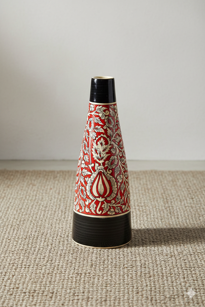 Decorative vase with red and white pattern on a beige surface