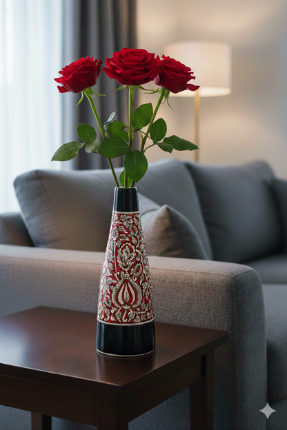 Decorative vase with red roses on a wooden table in a living room setting.