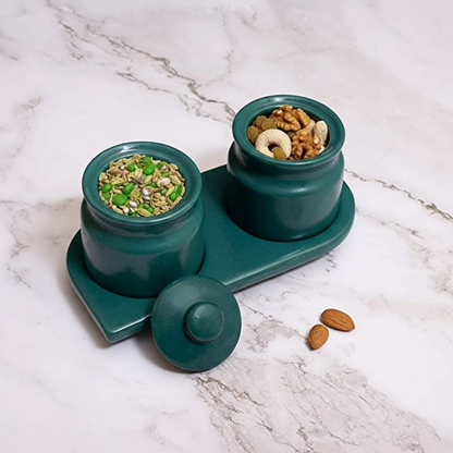Teal pet feeder with two compartments on a marble surface