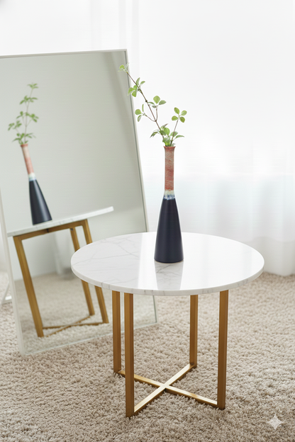 Round marble table with gold legs in a room setting