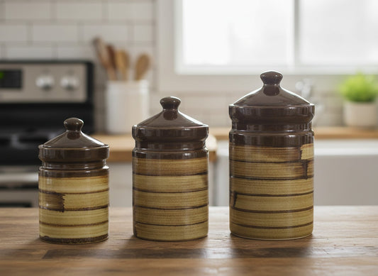 Three ceramic canisters with striped design on a kitchen counter
